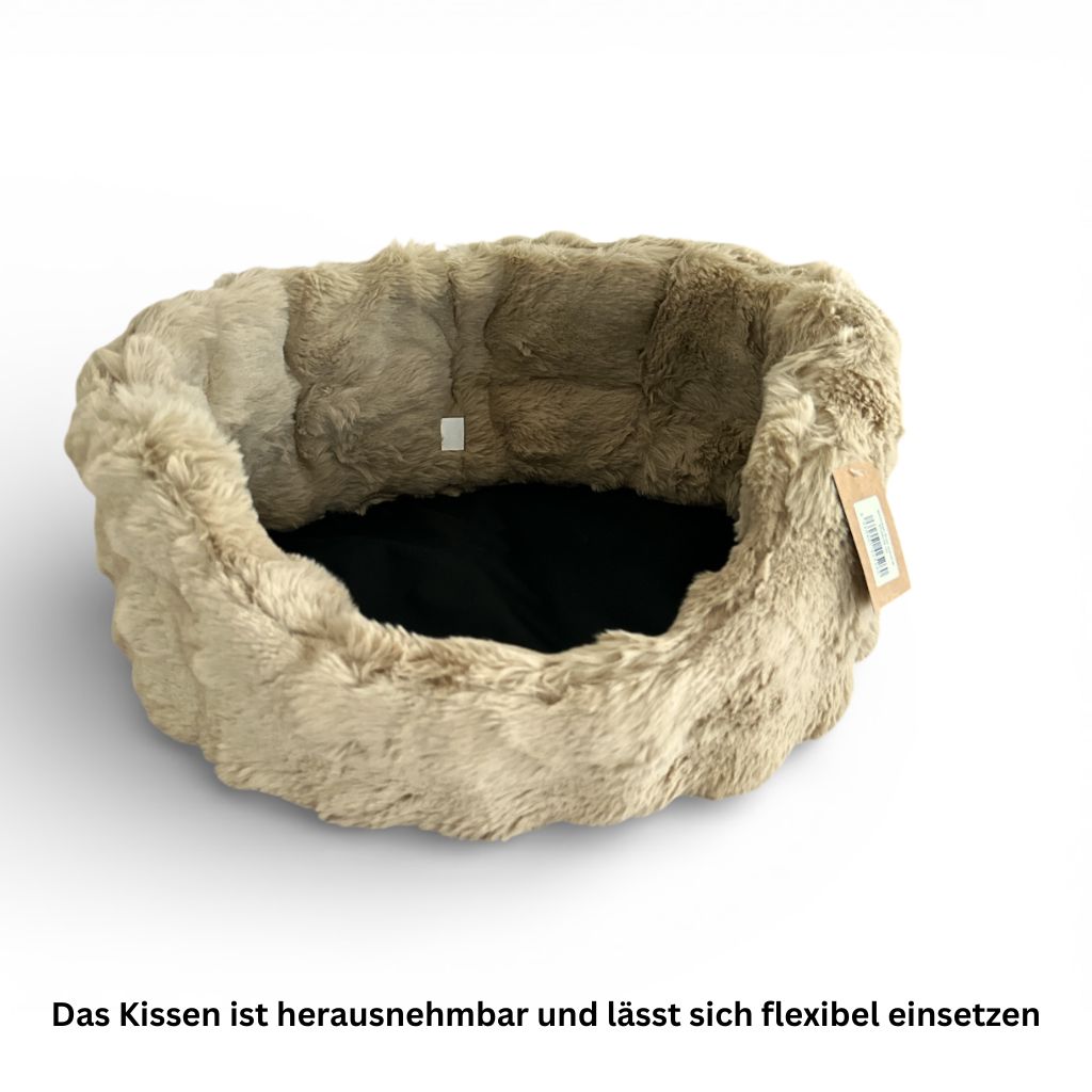 Beiges Hunde Bett Nomi ohne Hund mit formstabilem Rand und weicher Innenpolsterung.